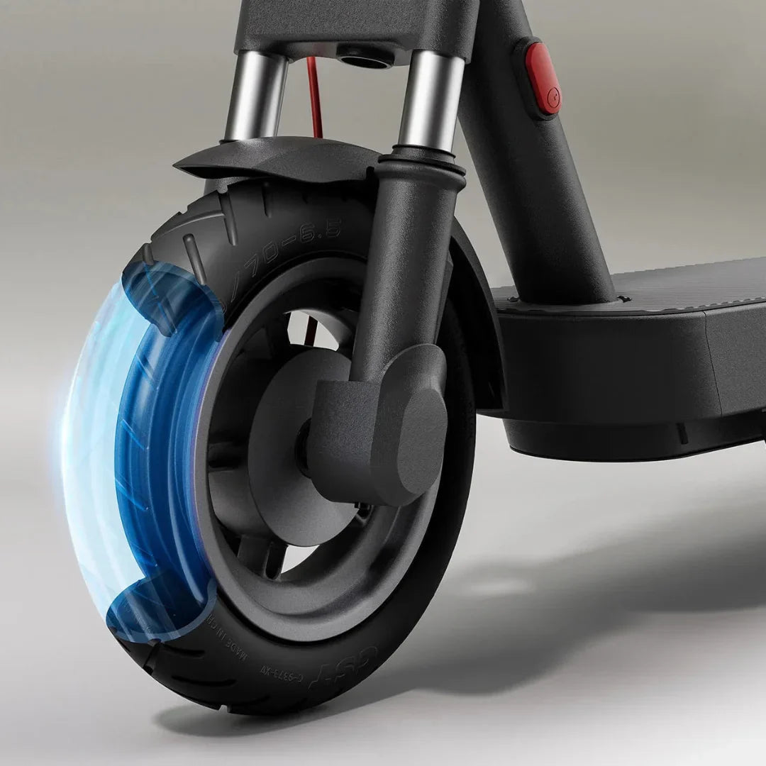 The product in the image is an Electric scooter, model Xiaomi 5 Max GL. The front part of the scooter is shown, including the wheel, which has a robust tire and is equipped with a shock absorption system. A red button device is also visible, likely for turning the scooter on or off. The overall design is minimalistic and modern, characteristic of the Xiaomi brand.
