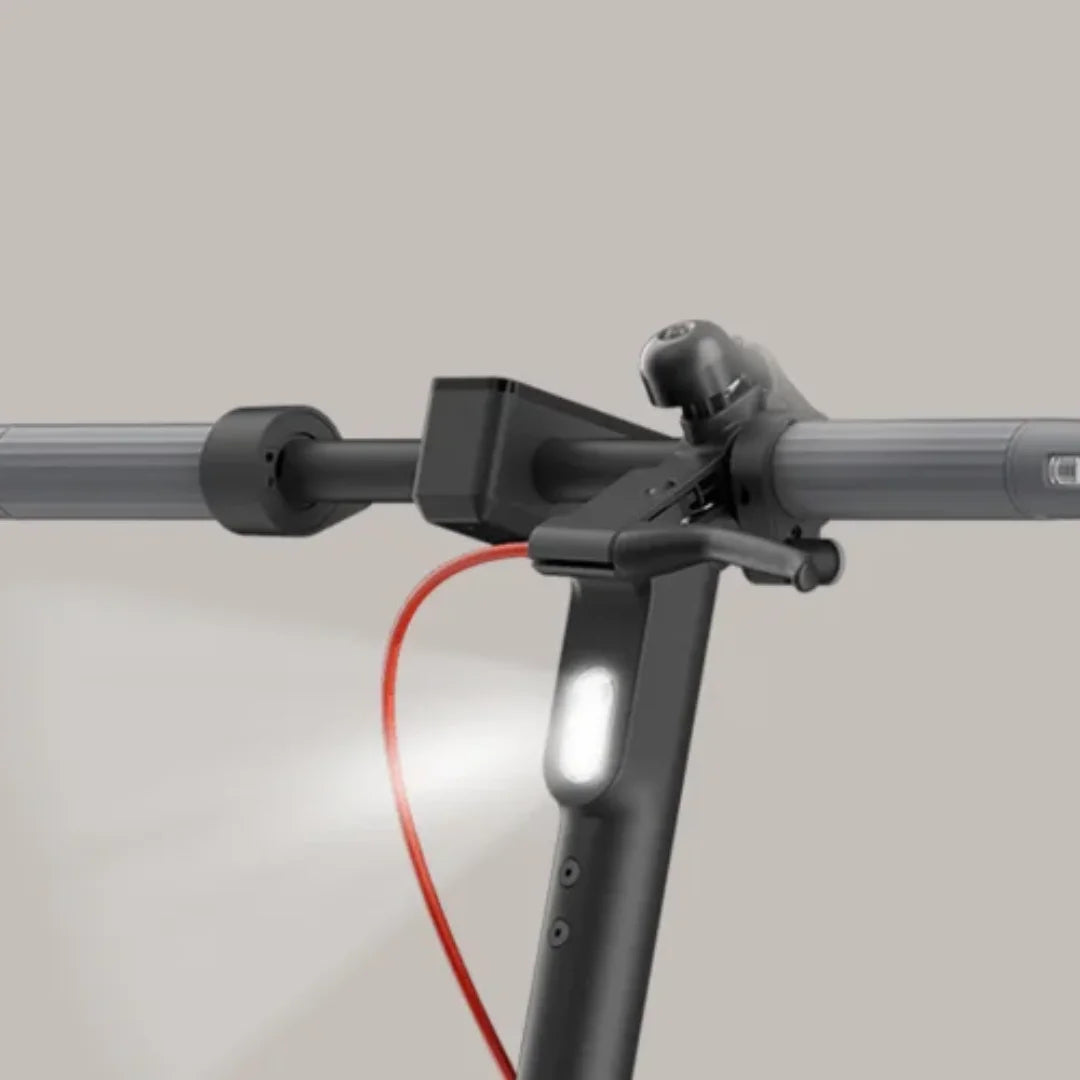 The product in the picture is an Electric Scooter, brand Xiaomi, model 5 Max GL. The picture shows part of the scooter's handlebars, where the grips, light, and bell button are visible. The overall design is modern and functional, ensuring a comfortable ride.