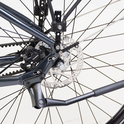 The product is an Electric bike, model Econo Mare City. The image shows the rear part of the bike, where the brakes and part of the frame are visible. Features include disc brakes, ensuring efficient stopping, and part of the mechanism for smooth operation. The frame color is dark, giving the bike a modern look.