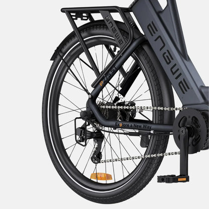 The image shows an Electric bike by Engwe, model P275 ST. The rear of the bike is visible, including the frame, chain, derailleur, and pedals. The bike has a robust construction and is equipped with wide tires and a rack for accessories. The frame features the inscription "Explore a New Way," suggesting a purpose of exploration and active leisure.