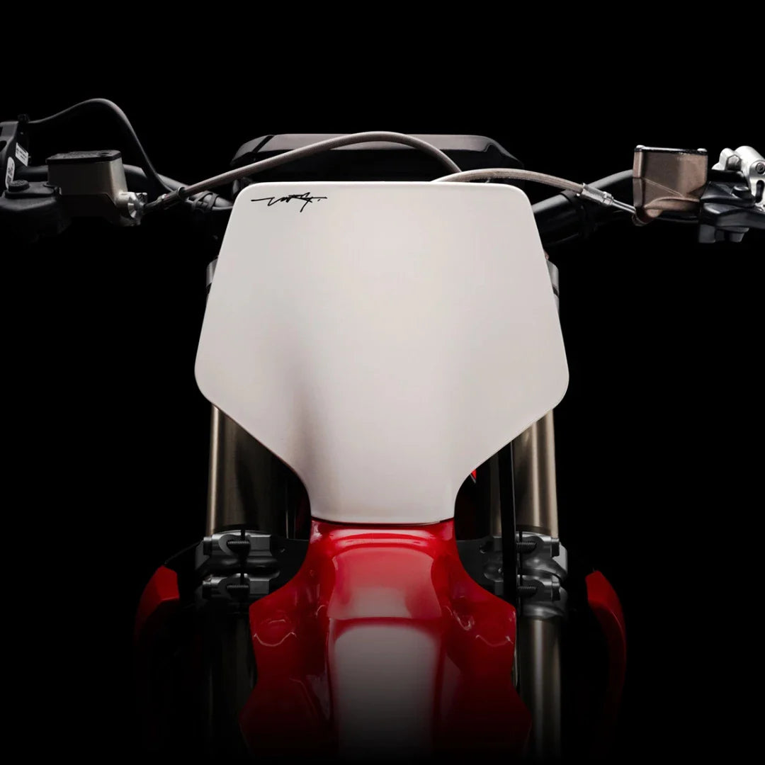 Close-up shot of the handlebars of a Stark Varg electric motocross bike on a black background.