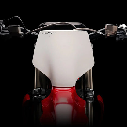 Close-up shot of the handlebars of a Stark Varg electric motocross bike on a black background.