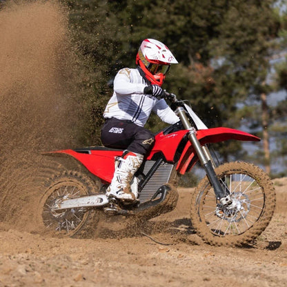 An Electric Motorcycle Stark Varg rider kicks up dust on the track.