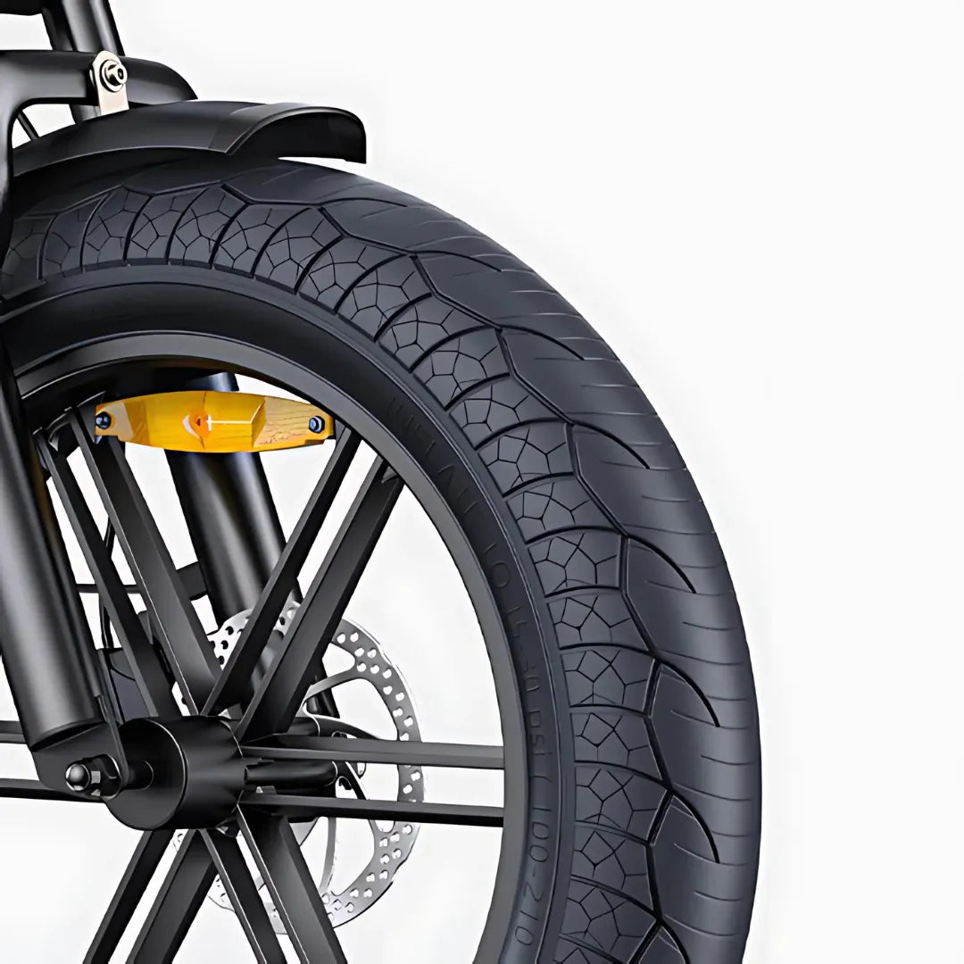 The product in the image is an electric bike, model Engwe M1. The image shows part of the front wheel, which includes a wide tire with a prominent tread, indicating good grip. The brake and part of the frame are also visible, suggesting a robust design for the bike.