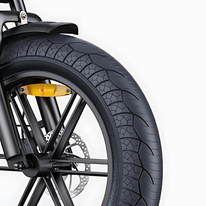 The product in the image is an electric bike, model Engwe M1. The image shows part of the front wheel, which includes a wide tire with a prominent tread, indicating good grip. The brake and part of the frame are also visible, suggesting a robust design for the bike.