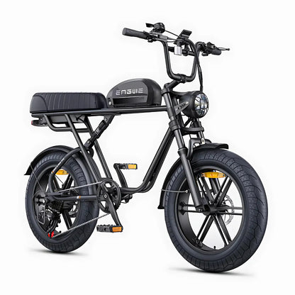 The product in the image is an electric bike, brand Engwe, model M1. The bike features a robust design, wide tires, and a comfortable seat. Handlebars and a light are visible on the front, indicating functionality for night riding. The entire construction is black, giving the bike a modern and sporty look.
