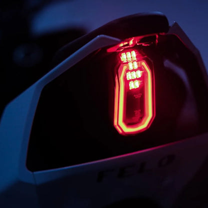 Close-up shot of the Felo Fw 06 electric scooter's tail lights, glowing red in dim light.