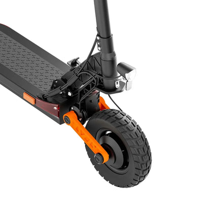 The product shown is an electric scooter, model Joyor S10 S-Z. The image displays the scooter's front wheel assembly, which includes a robust wheel with a patterned rubber tire for better stability and grip. Also visible is the front light, ensuring visibility during rides. A red reflective marker on the side adds extra safety. The overall design is sleek and functional, characteristic of this brand.