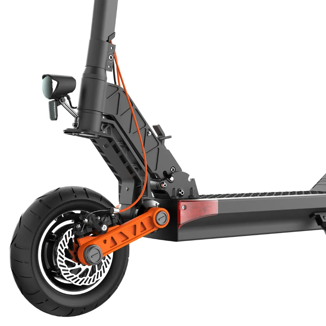 The product in the image is an Electric scooter by Joyor, model S10. The image shows a part of the scooter, including the rear wheel, brakes, and frame. It is equipped with a thick rubber wheel and characteristic elements such as the braking system and footboard, indicating a robust design for a comfortable ride.