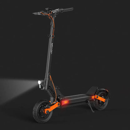 The product pictured is an electric scooter, brand Joyor, model S10 S-Z. The image shows the scooter's modern design, which includes wide wheels, a robust frame, and a front light. The black and orange color combination adds a dynamic look, while red lights are visible on the rear of the scooter, increasing visibility when riding in the dark.