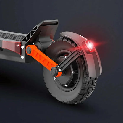 The product pictured is an Electric Scooter, model Joyor S10 S-Z. The image shows the rear of the scooter, featuring a large tire with a deep tread for better grip. It's equipped with a red taillight to enhance visibility and safety when riding in the dark. A red element on the handlebar arm adds color contrast and aesthetic appeal.