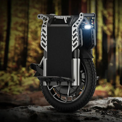 The product in the picture is an electric unicycle, model KingSong F22 Pro. The image shows a unicycle with a modern design, including a wide tire and a robust frame. A front light is also visible, indicating the possibility of riding in low-light conditions. The background of the picture shows a forest environment, giving a sense of adventure and nature.