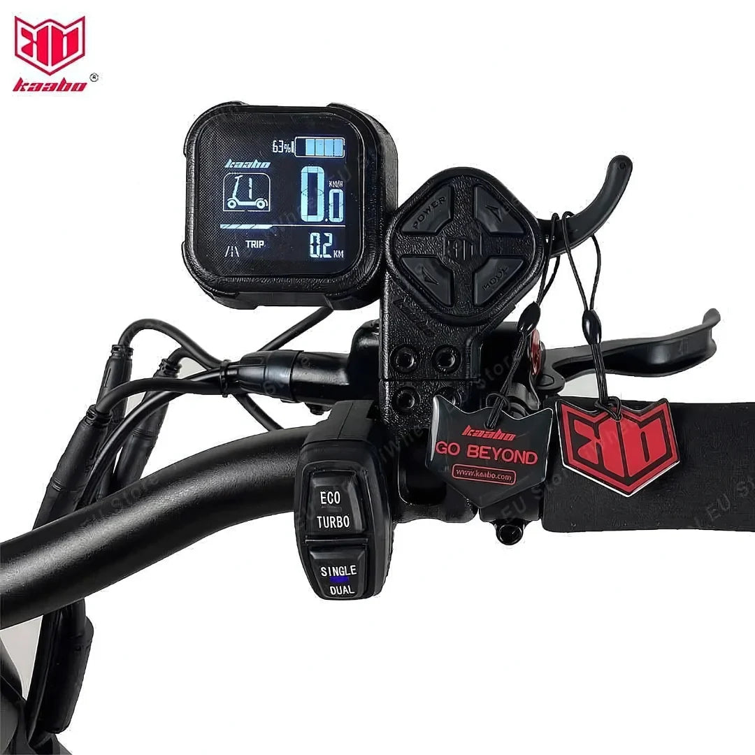 The product is an Electric Scooter Kaabo Mantis 10 Plus. The image shows a part of the handlebars, displaying a digital screen and control buttons. The screen shows speed, distance traveled, and battery status, while the buttons allow selection between different riding modes, such as ECO and TURBO.