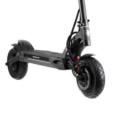The image shows an electric scooter from the brand Kaabo, model Mantis 10 Plus. The front of the scooter is visible, featuring wide wheels with tires for enhanced stability and grip. Also displayed are the brakes and a section of the frame, designed for a comfortable ride. The scooter's color is dark gray, giving it a modern look.