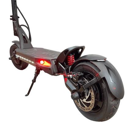 The product is an Electric Scooter, Kaabo brand, Mantis 10 Plus model. The image shows the rear of the scooter, which includes a wide rear wheel, disc brakes, and a red light, indicating its functionality and safety features. It is also equipped with a suspension system, contributing to a more comfortable ride.