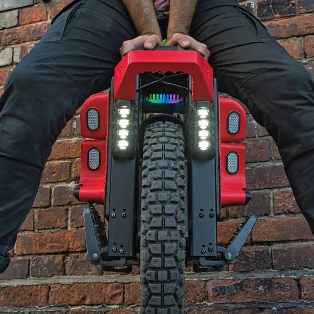 The product in the image is an Electric Unicycle (EUC), model KingSong S22 Pro. The image shows the front of the unicycle, which has a wide tire with a prominent tread, indicating its ability to ride on various terrains. Lighting elements are also visible, adding to its aesthetic appeal and functionality, along with a robust construction that suggests durability and performance.
