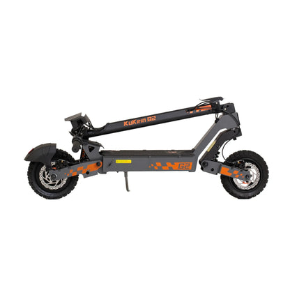 The product pictured is an Electric Scooter KuKirin G2. The scooter is shown in a folded state, allowing for easy transport and storage. It features a robust construction, wide tires for better stability, and a clearly marked model on the deck. The black and orange color combination gives the scooter a sporty look.