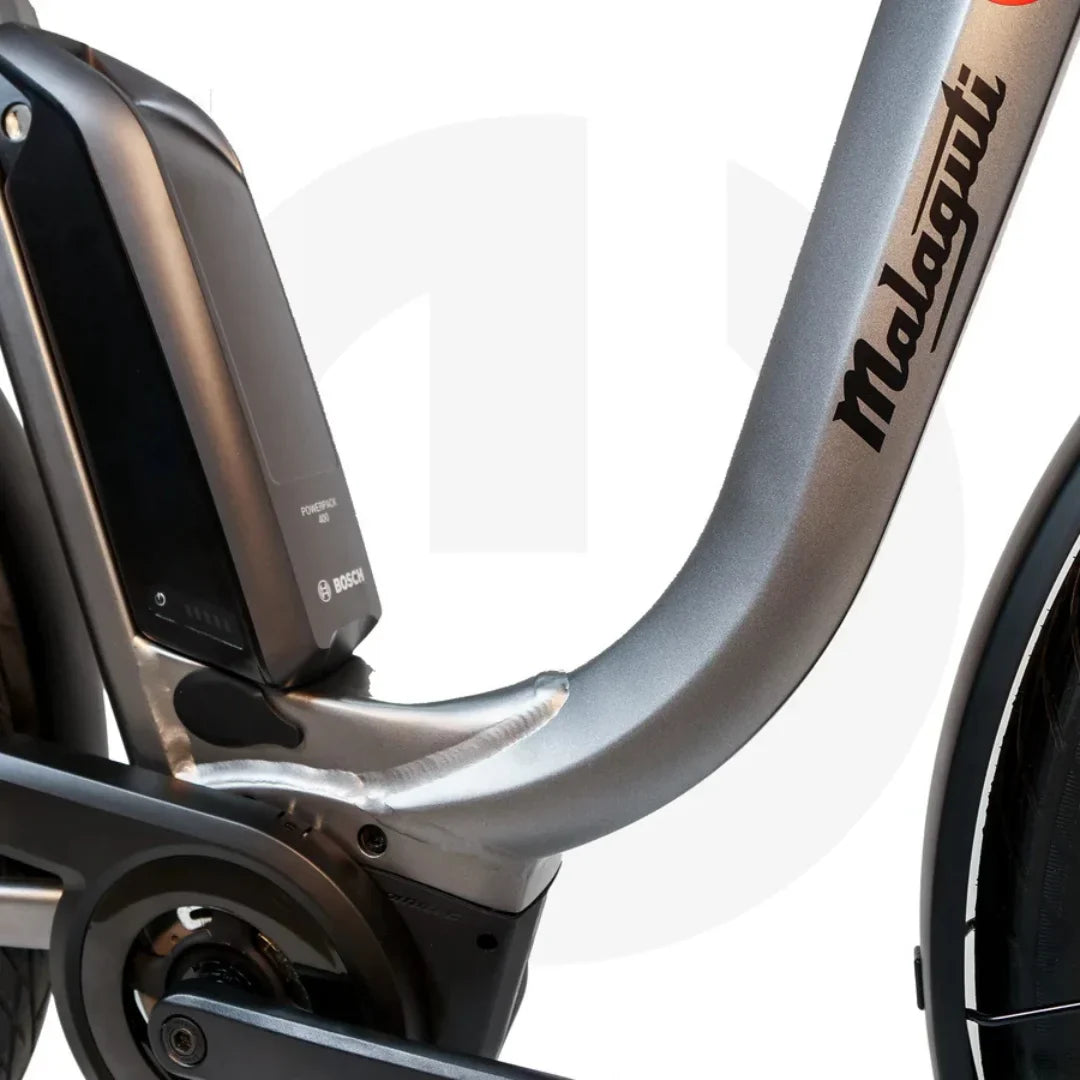 The product pictured is a Malaguti electric bike, model Bolonina. The image shows a Bosch battery mounted on the bike's frame, indicating its electric propulsion. The frame design is modern and aerodynamic, typical of contemporary electric bikes.