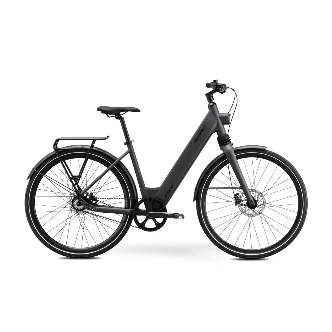 The product is an electric bike, brand MS Energy, model C300. The image shows a modern electric bike with a simple design, including wide tires, a comfortable seat, and an integrated battery within the frame. The bike also features a luggage rack and disc brakes, highlighting its functionality and comfortable ride. The overall look is elegant and minimalist, typical of contemporary electric bikes.