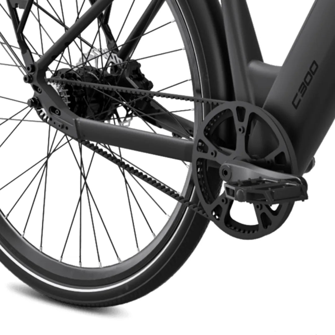 The image shows an electric bike from MS Energy, model C300. The rear view of the bike is displayed, showing part of the frame, the chain, and the pedal. The bike features a modern design with disc brakes and wide rims, indicating good performance and stability during rides.