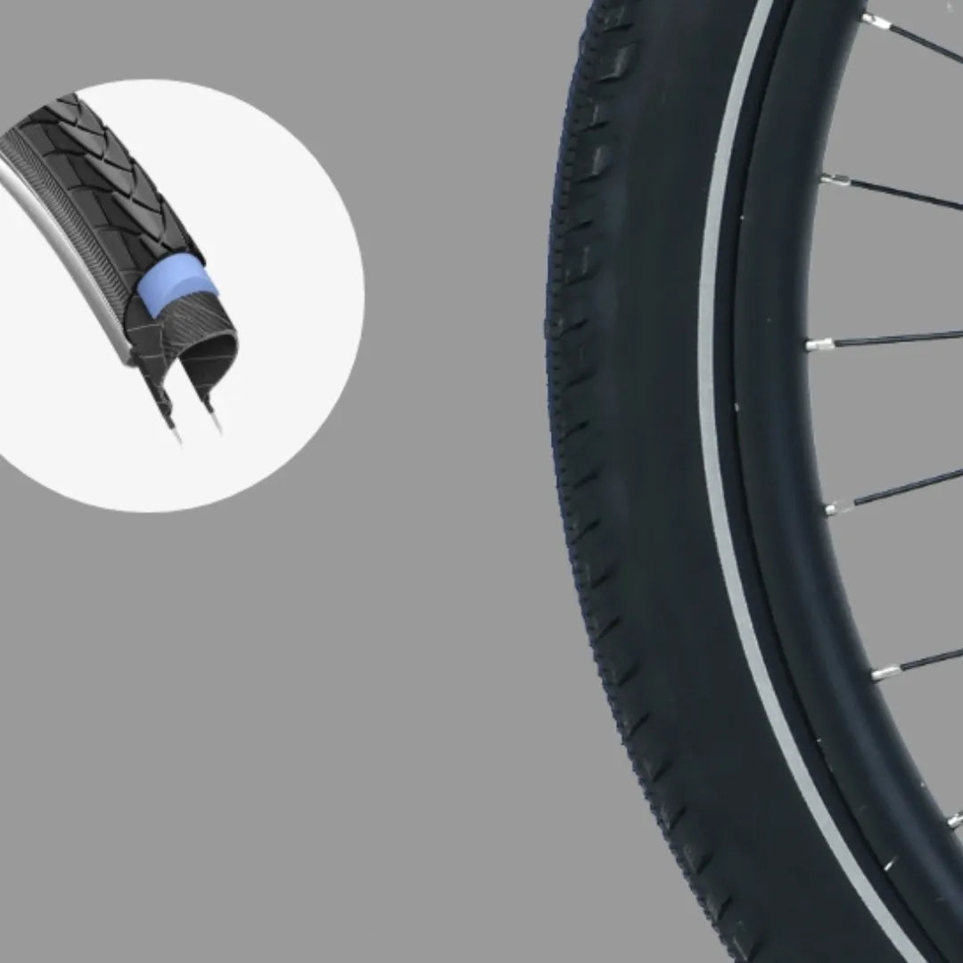 The product is an Electric bike, model MS Energy C300. The image shows the bike's tire, which has a distinctive tread pattern and is equipped with puncture protection. The tire's structure is also visible, indicating its quality and performance.