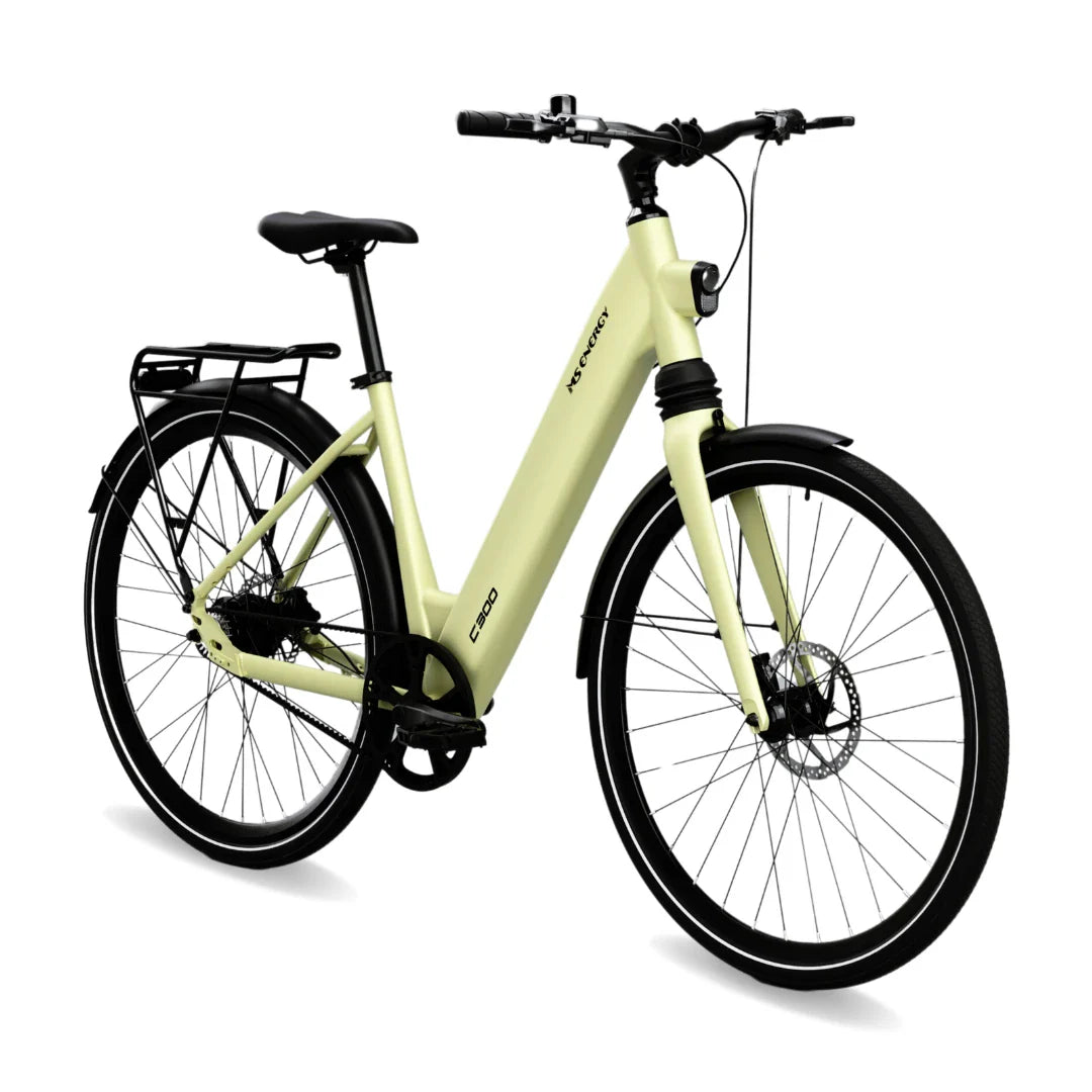 The product pictured is an electric bike from the brand XS Cycle, model C300. The bike has a bright yellow frame and is designed with an emphasis on comfort, featuring a low crossbar for easy mounting. It is equipped with a disc brake system and a luggage rack, making it suitable for city riding and longer trips.