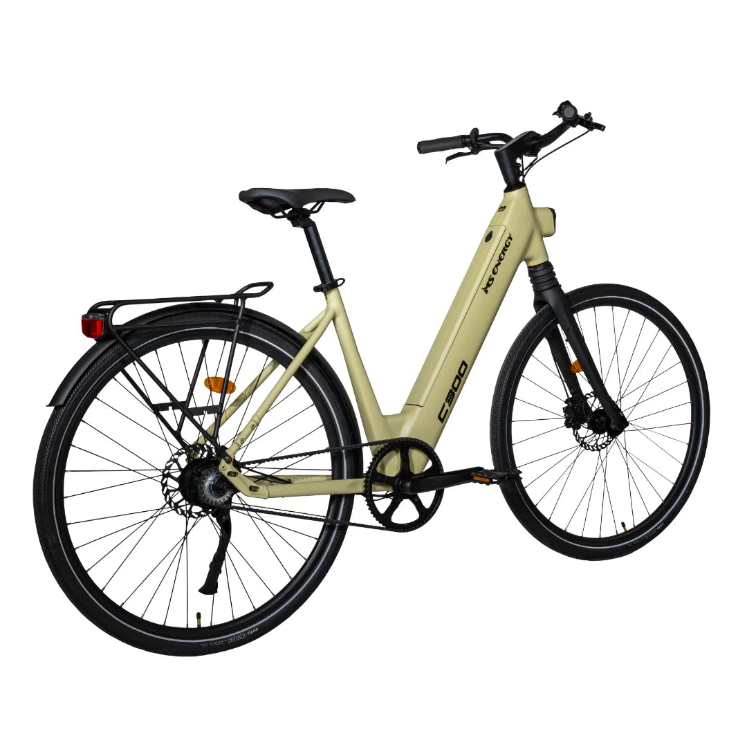 This product is an electric bike from the brand MS Energy, model C300. The image shows the bike in a light beige color, featuring a comfortably designed frame and wide tires. It is equipped with a rear rack and a disc brake system, which provides better stability and safety during the ride. The bike is designed for easy use and comfortable riding on urban paths.