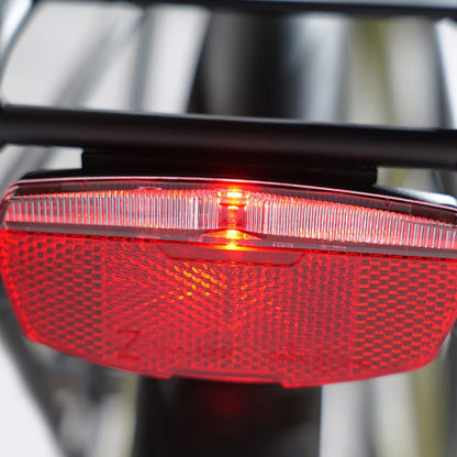 The product shown is an electric bike, model MS Energy C300. The image displays the rear reflector and light, which are part of the bike's safety equipment. The red light is on, increasing the rider's visibility in the dark. The reflector is designed for additional safety during rides.