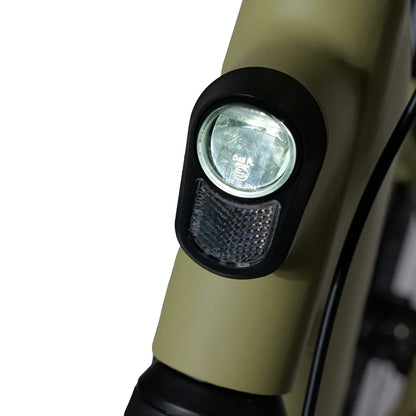 The product is an Electric Bike, model MS Energy C300. The image shows the front light, mounted on the bike frame, and part of the frame in olive green. The light is designed to improve visibility and safety while riding.