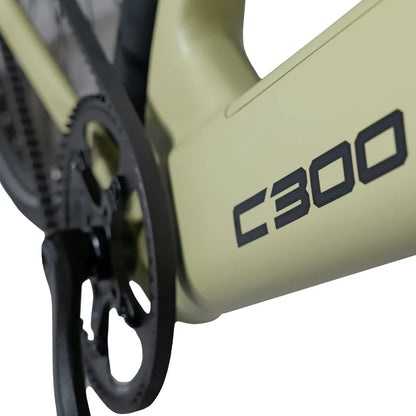 The product is an electric bike, model C300, from the brand MS Energy. The image shows a detail of the bike's frame in light green, with the model C300 clearly marked. The chain and pedal system are also displayed, highlighting the bike's technical features.