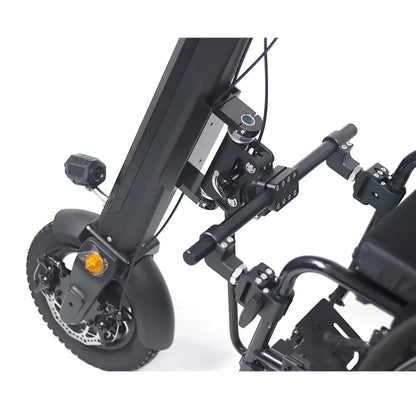 The product shown is an electric attachment for wheelchairs, model Mijo MT01. The image displays the structure of the attachment, which includes the part for connecting to the wheelchair and wheels with brakes. Some mechanisms for adjustment and stability are also shown. The overall design is engineered for ease of use and mobility.