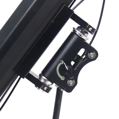 The product in the image is an electric trailer hitch, model Mijo MT01. The image shows a part of the hitch, including a metal mechanism and connecting elements. Cables are also visible, indicating an electrical connection. The overall design is minimalist and functional.