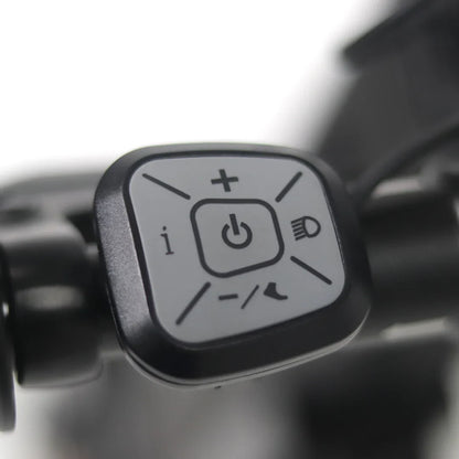 The image shows a part of the Mijo MT01 electric scooter. A control unit with three buttons is visible, including a power button, speed increase and decrease buttons, and a light button. The control unit is designed for easy operation of the scooter's functions.