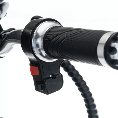 The product is an Electric Mobility Scooter, model Veleco ZT16. The image shows a part of the handle with a control button, allowing for easy steering. The handle is equipped with an ergonomic grip, ensuring comfortable use during the ride.