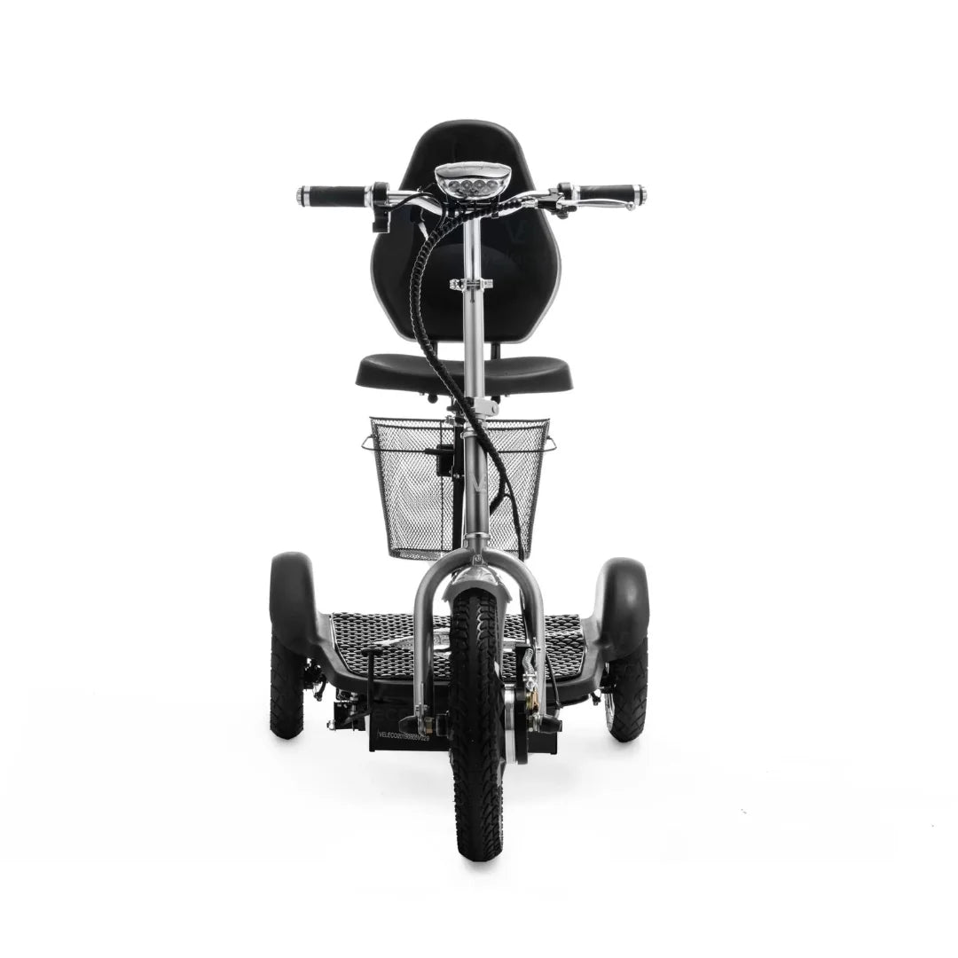 The product is an Electric Mobility Scooter, model Veleco ZT16. The image shows the front part of the scooter, which features a comfortable seating area and handlebars. A metal basket is visible at the front, perfect for storing smaller items. The scooter has wide tires, ensuring stability and a comfortable ride.