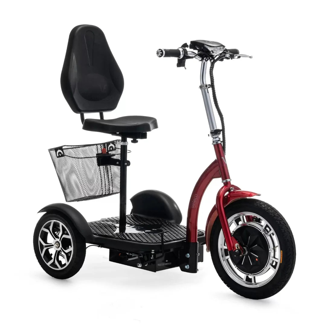 The product pictured is an Electric mobility scooter, model Veleco ZT16. It features a comfortable seat and a wide footboard, ensuring ease of use. A mesh storage basket is located at the back, and large wheels are visible at the front, providing stability and a comfortable ride. The scooter's red color gives it an attractive appearance.