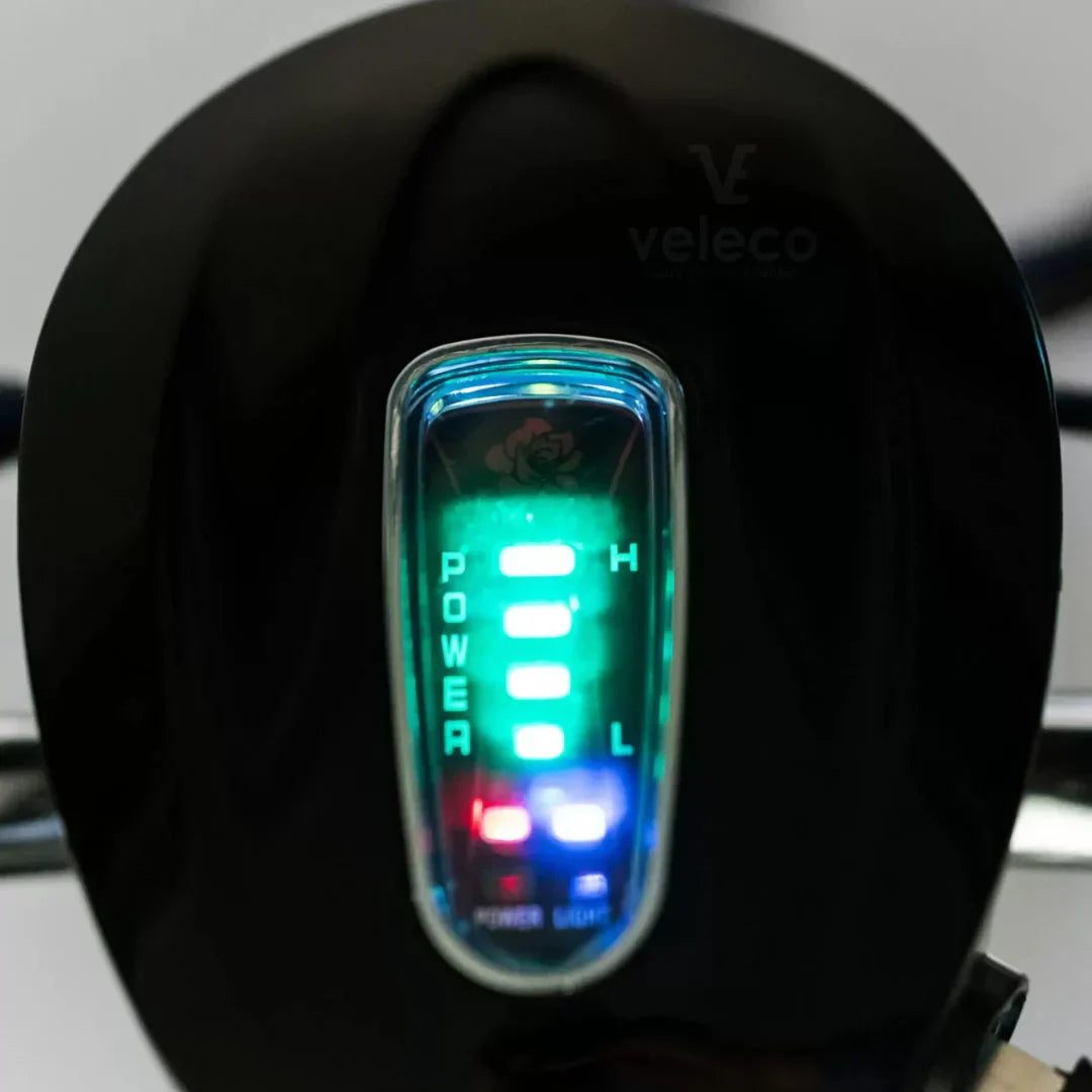 The product is an Electric Mobility Scooter, model Veleco ZT16. The image shows a part of the control panel, where LED indicators for power and battery level are visible. The indicators are illuminated in different colors, allowing the user to easily monitor the scooter's status. The Veleco brand is known for its electric mobility solutions.